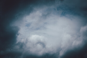 A cloudy sky with a dark blue hue