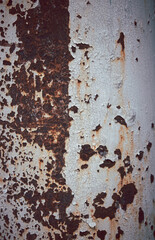 A rusty pole with a white stripe