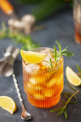Summer fresh cocktail with lime and ice in a glass on a dark background
