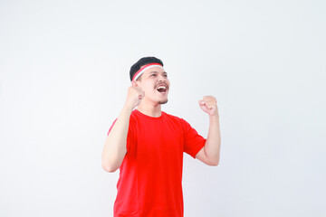 Excited young Asian man clenched fist showing excitement during celebrating indonesian independence day on 17 august isolated on white background
