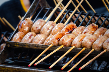 A grill with skewers of meat on it