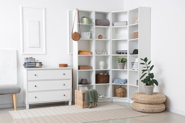 Stylish interior of light room with clothes and decor