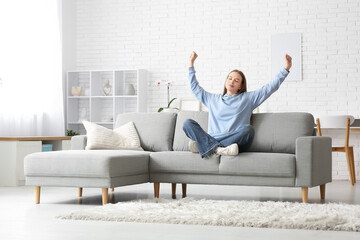 Young tired woman resting on sofa in stylish living room