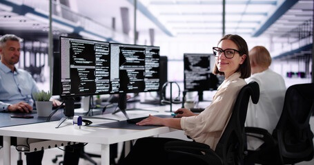 African American Coder Using Computer At Desk