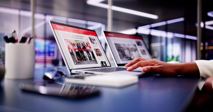 American Woman Views Online News Articles on Laptop and Phone While Relaxing