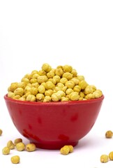 Roasted Bengal Gram or Chickpea in a Red Bowl Isolated on White Background with Copy Space, Also Known as Garbanzo Bean or Egyptian Pea in Vertical Orientation