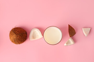 Glass of coconut milk on pink background
