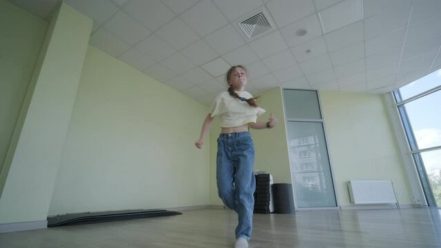 Young Girl Breakdancing in Modern Studio