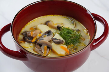 Delicious soup with mushrooms champignon and potato.Creamy Chanterelle Soup .Nordic cuisine. Vegan soup