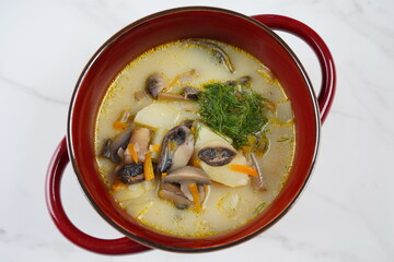 Delicious soup with mushrooms champignon and potato.Creamy Chanterelle Soup .Nordic cuisine. Vegan soup