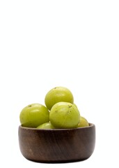 Indian Gooseberry Fruit or Amla Fruit in a White Bowl Isolated on White Background with Copy Space, Also Known as Emblica Myrobalan or Phyllanthus Emblica in Vertical Orientation