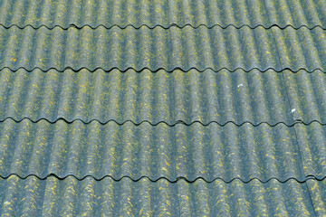 The roof is covered with old slate. Colorful slate background.