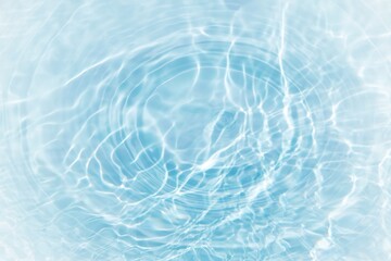 Blue water with ripples on the surface. Defocus blurred transparent blue colored clear calm water surface texture with splashes and bubbles. Water waves with shining pattern texture background.	