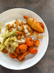 Malaysian styled complete meal for lunch or dinner called Nasi Campur.  It is plain white rice served with variety of dishes.