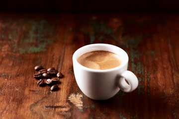Cup of coffee on wooden background.