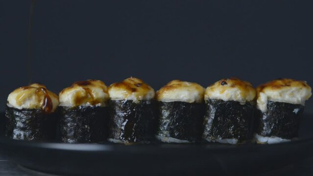 Baked rolls drizzled with unagi sauce