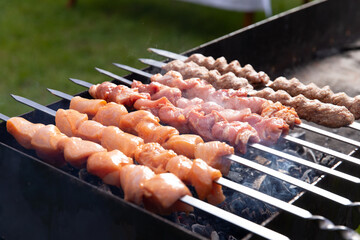 Various kebabs are grilled on the grill.