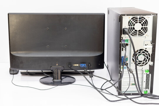 Backside View of a Desktop Computer and Monitor with Connected Cables. Rear View with Connected Cables.