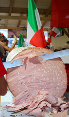 Giant mortadella sliced with a long knife during the town festival
