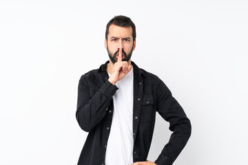 Fototapeta premium Young man with beard over isolated white background showing a sign of silence gesture putting finger in mouth