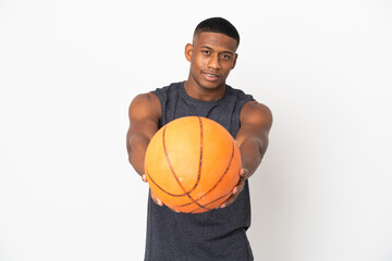 Obraz premium Young latin man isolated on white background playing basketball and proud of himself