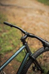 Obraz premium Photo of a bicycle in the park, top view of the handlebars