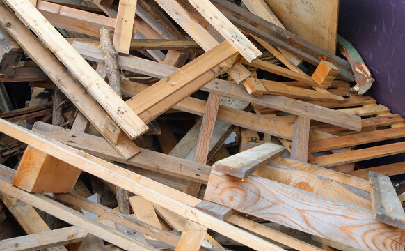 wooden pieces planks and pallets in the wood recycling container at the landfill for proper waste disposal