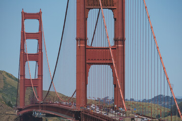 Fototapeta premium World famous red steel suspension bridge in San Francisco port entrance with Golden Gate State park nature landscape coastal California panoramic beauty scenery
