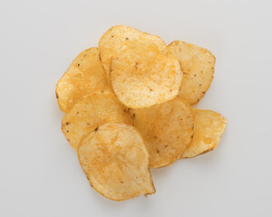 Organic potato chips heap from above on white
