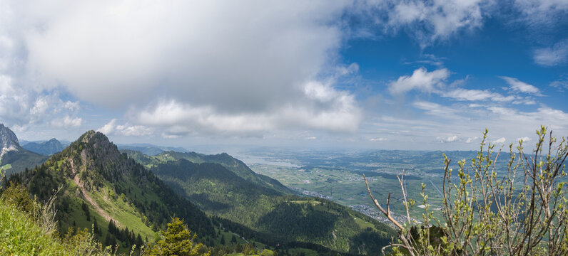 Large panorama of the Linth plain from the Hirzli mountain in summer with blue sky and clouds