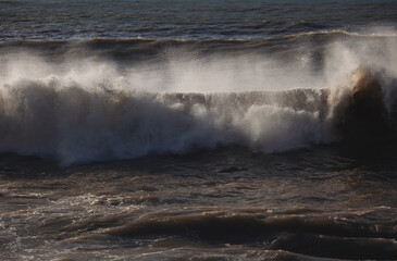 Windy sea wave. Detailed view of beautiful big crashing waves in a stormy day. 