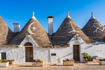 Famous historical old dry stone trulli houses with conical roofs in Alberobello, Italy.
