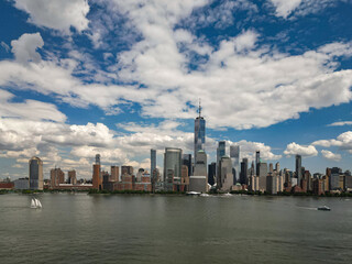 Fototapeta premium New York City top view. NYC aerial view, New York City Skyline with dramatic sky. Panoramic drone view on Manhattan in NY. Sunset in NYC. New York City Midtown skyline view at dusk with clouds.