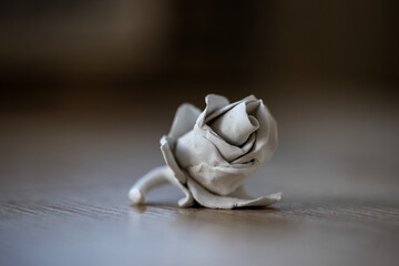 Close-up on a rose made of clay. Homemade clay objects.