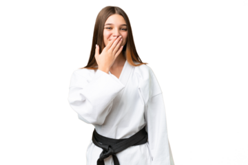 Teenager girl doing karate over isolated chroma key background happy and smiling covering mouth with hand