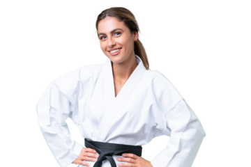 Young Uruguayan woman doing karate over isolated background posing with arms at hip and smiling