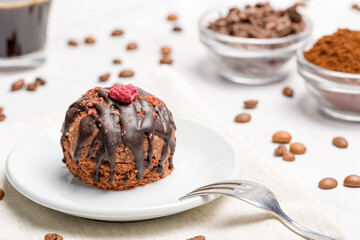 Round chocolate cakes. Decorated with candied raspberries. Light background