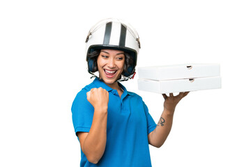 Pizza delivery Argentinian woman with work uniform picking up pizza boxes over isolated background celebrating a victory
