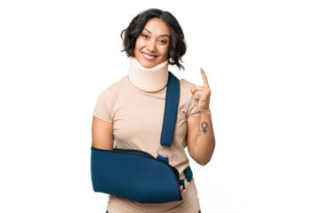 Young argentinian woman wearing neck brace and sling over isolated background showing and lifting a finger in sign of the best