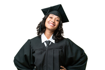 Young university graduate Argentinian woman over isolated background posing with arms at hip and smiling