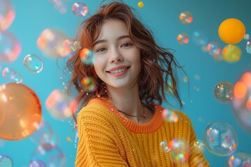 Cute happy young woman in a yellow sweater with colorful bubbles floating above her head isolated on a light turquoise background,