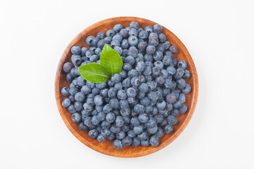  A shrub of the azalea family. The fruit is light blue or black in color and has white powder on the outside.
