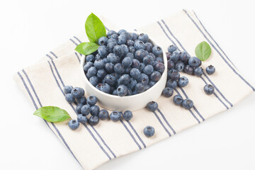  A shrub of the azalea family. The fruit is light blue or black in color and has white powder on the outside.
