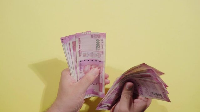 Counting Two Thousand (2000) Indian Rupees Notes