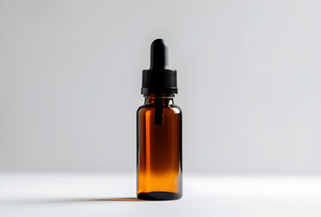 Amber glass dropper bottle with black cap isolated on white background