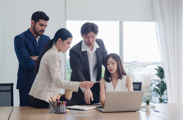 Business team woman and man asian group meeting sit look holding document and look computer talking new project marketing creative write note plan ready for happy working inside room office company
