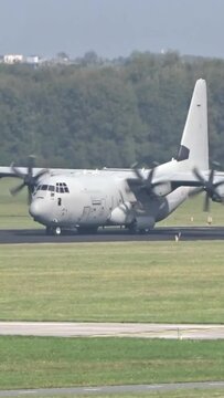 Generic Military Army Transport airplane taxiing on the runway prior take off for a mission evacuation