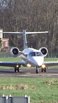 Business Private Corporate Executive Jet Taxiing and Turning off the Runway after landing at International Airport.
