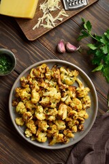Roasted cauliflower on wooden background
