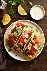 Tacos with vegetables and meat on wooden background